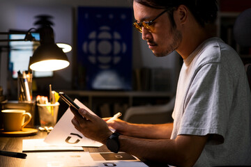 Aufkleber - Asian man graphic designer working on computer drawing sketches logo design. The concept of a new brand. Professional creative occupation with idea.