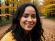 © mikhailberkut - Photorealistic portrait of positive beautiful very young laughing woman with loose frizzy hair fluttering in the wind with autumn yellow, red leaves on background of an autumn forest