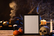 Black frame with copy space, skull, candles and smoke on black background