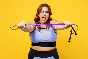 Wall Mural - Young fun chubby overweight plus size big fat fit woman wear blue top warm up training hold in hand give skipping rope scream isolated on plain yellow background studio home gym Workout sport concept