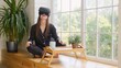 Beautiful young girl in a virtual reality headset. Drinking morning coffee and putting on VR goggles. Happy cute woman touching something using modern 3d vr glasses indoors.
