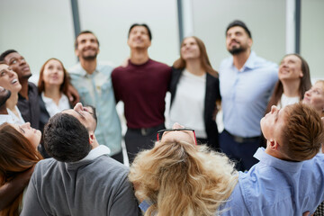 Wall Mural - Team of young people hugging in the office.