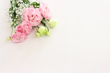 Wall Mural - Top view image of delicate pink flowers over white background