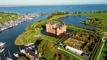 Aerial View On Muiderslot Castle In Muiden, Netherlands, Flying Backwards. The Castle Dates From The Late 14th Century.