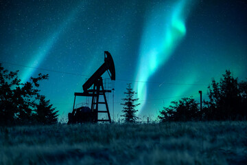 Wall Mural - pump jack silhouette on night sky with northern light. oil pump against incredible nirght sky with a