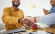 Creative people, handshake and meeting in celebration, promotion or partnership in teamwork at office. Happy employees shaking hands in team recruiting, agreement or deal in startup at the workplace