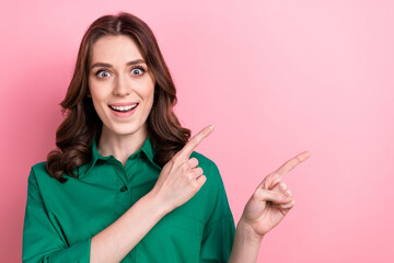 Poster - Photo of cheerful excited woman dressed green shirt open mouth showing two fingers empty space isolated pink color background