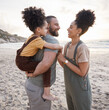 © Wesley/peopleimages.com - Piggyback, family and smile at beach at sunset, bonding and having fun together. Happy, mother and father of kid at ocean in interracial care on summer holiday, vacation trip or travel outdoor at sea