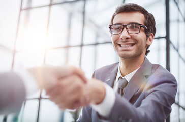 Wall Mural - young businessman shaking hands with his partner