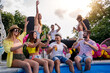 © ivanko80 - Friends sitting by poolside and drink beers while listening music
