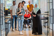 © .shock - A diverse group of young business people congregates within a modern startup's glass-enclosed office, featuring inclusivity with a person in a wheelchair, an African American young man , and a hijab