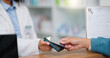 © Felix/peopleimages.com - Closeup customer hands using ebanking credit card to pay on contactless nfc machine to collect prescription medication from pharmacist. Man tapping or scanning electronic device for pharmacy medicine