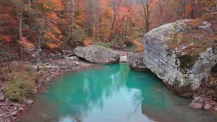 Wall Mural - Rising aerial shot revealing beautiful pool of water in Arkansas ozark mountain creek via aerial drone in autumn
