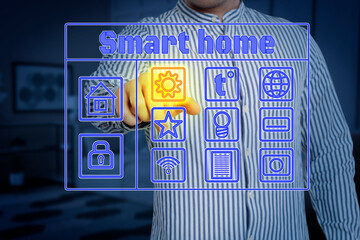 Canvas Print - Smart home system. Man using digital interface in room, closeup