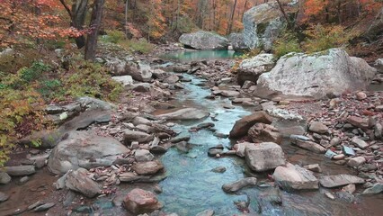 Wall Mural - Flight beautiful turquoise pool of water and fall colored rocky creek in the Arkansas ozark mountains in autumn 
