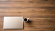 Laptop and coffee cup on wooden table, top view with copy space