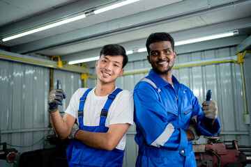 Wall Mural - Happy workers in teamwork standing together smiling friendly enjoy working in heavy metal industry. Industrial plant concept.