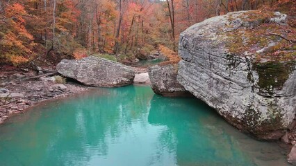 Wall Mural - Beautiful Arkansas turquoise pool of water and large boulders in ozark mountain creek in autumn