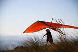 man preparing to take off with his hang glider