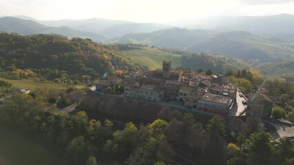 Poster - Aerial of the medieval Montefabbri town in Italy with the big hills and mountains in the background