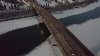 Poster - Aerial of the traffic on the bridge over the frozen lake during a cold winter day