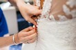 the bride puts her wedding ring on the brides dress