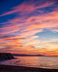 Wall Mural - sunset on the coast of zumaia with view of the flysch rocks and cloudy dramatic red sky