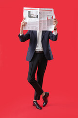 Poster - Young man in suit reading newspaper on red background