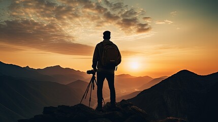 Wall Mural - Mountain man wearing gray shirt and brown shorts holds black DSLR camera. silhouette concept