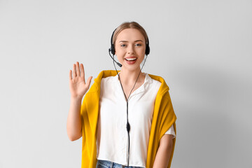 Wall Mural - Female technical support agent  on light background