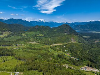 Wall Mural - Aerial view of a breathtaking natural landscape, featuring a lush green valley in Mission, Canada