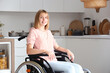 Young woman in wheelchair at home