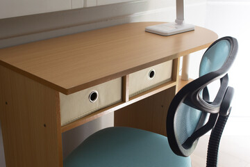 A view of a study desk and computer chair.