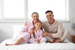 © Pixel-Shot - Little girl with her parents in bedroom