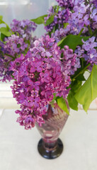Wall Mural - bouquet of beautiful lilac in a glass vase