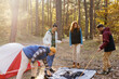 © Oleksii Syrotkin/Stocksy - Team set up tent wilderness forest shelter hiking gear