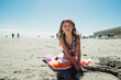 © Maria Manco/Stocksy - portrait of tween girl on beach