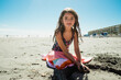 © Maria Manco/Stocksy - Tween girl on the beach
