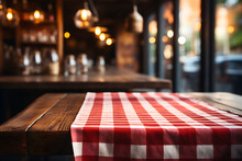 Red And White Checkered Tablecloth On Wooden Table, With Blur Cafe, Restaurant Background