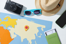 Flat Lay Traveler Accessories On Map Background With Devices, Camera