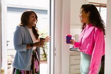 Excited Woman At Door With Coffee