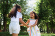 © Danil Nevsky/Stocksy - Happy preteen sisters enjoying summer in woods