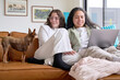 © Rowena Naylor/Stocksy - Young lesbian couple at home with pet dog