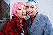 © Roman Shalenkin/Stocksy - Stylish female LGBT friends with dyed hair in urban city