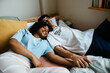 © BONNINSTUDIO/Stocksy - Cheerful couple cuddling on bed