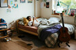 © BONNINSTUDIO/Stocksy - Teen boy using phone in bed