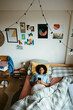© BONNINSTUDIO/Stocksy - Teen girl using phone in bed