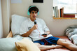 © BONNINSTUDIO/Stocksy - Man recording a podcast on bedroom