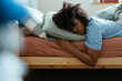 © BONNINSTUDIO/Stocksy - Female teen sleeping on bed