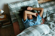 © BONNINSTUDIO/Stocksy - Woman sleeping on bed